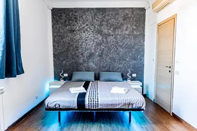 a bedroom with a bed against a wall at Terrace with view of Cupola San Pietro - Casa Claudia in Rome