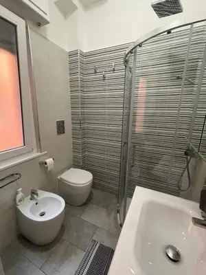 a bathroom with a toilet and a sink and a shower at Bittersweet Apartment in Rome