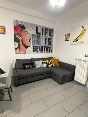 a living room with a couch and a banana on the wall at Bittersweet Apartment in Rome