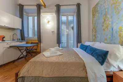 a bedroom with a large bed with blue pillows at Campo De Fiori Apartments in Rome