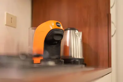 an orange mixer sitting on top of a counter at Campo De Fiori Apartments in Rome