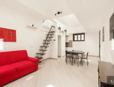 a living room with a red couch and a table at Trastevere City Life Apartments in Rome