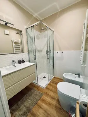 a bathroom with a shower and a toilet and a sink at Domus Antea in Rome