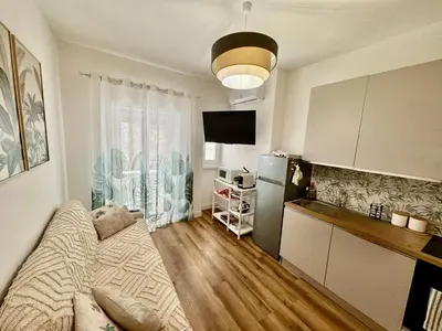 a small apartment kitchen with a bed and a refrigerator at Domus Antea in Rome