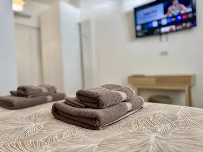 a pile of towels sitting on top of a bed at Domus Antea in Rome