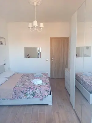 a bedroom with a bed and a mirror at Danielas House in Rome