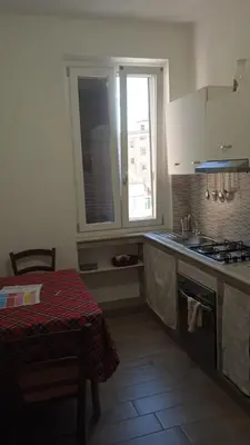 a kitchen with a sink and a stove and a window at Danielas House in Rome