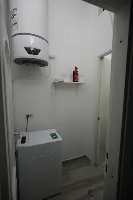 a bathroom with a sink and a light on the wall at Camera con bagno in posizione strategica in Rome