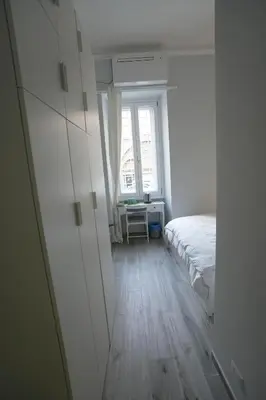 a white bedroom with a bed and a window at Camera con bagno in posizione strategica in Rome