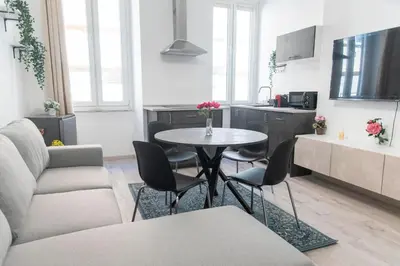 a living room with a table and chairs and a kitchen at LUXURY BABUINO -exclusive apartment in Rome
