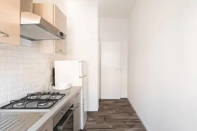 a kitchen with a stove and a refrigerator at La Dimora Arimondi in Rome