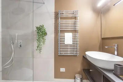 a bathroom with a sink and a glass shower at Vatican Museums Stay with Terrace in Rome