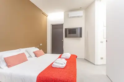 a bedroom with a bed with towels on it at Vatican Museums Stay with Terrace in Rome