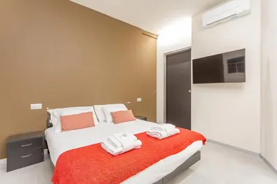 a bedroom with a bed with towels on it at Vatican Museums Stay with Terrace in Rome