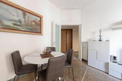 a dining room with a white table and chairs at Macedonia 30 Bright Flat in Rome