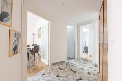 a hallway with white walls and a tile floor at Macedonia 30 Bright Flat in Rome