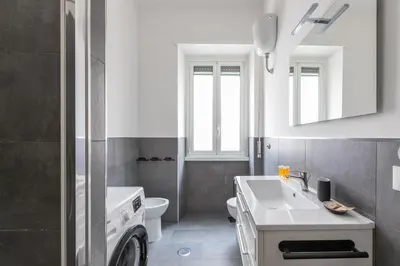 a bathroom with a white sink and a toilet at Macedonia 30 Bright Flat in Rome