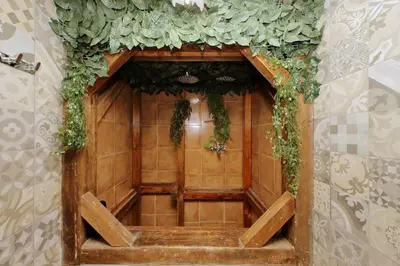 a wooden door with green ivy on a wall at 4BNB - Victoria Palace in Rome