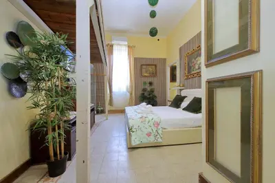 a bedroom with a bed and a mirror at 4BNB - Victoria Palace in Rome