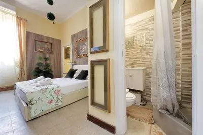 a bedroom with a bed and a toilet in it at 4BNB - Victoria Palace in Rome