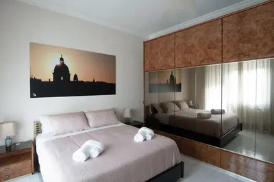 a bedroom with two beds with white towels on them at Happio Apartment in Rome in Rome