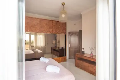 a bedroom with a bed with two towels on it at Happio Apartment in Rome in Rome