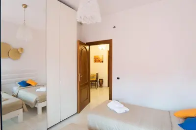 a bedroom with two beds and a mirror at Happio Apartment in Rome in Rome