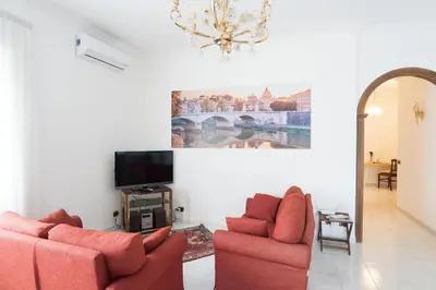a living room with two couches and a tv at Happio Apartment in Rome in Rome