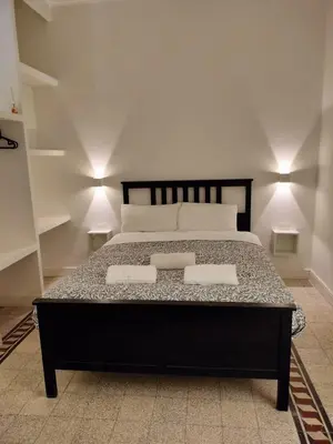 a bedroom with a large bed with two pillows at Vatican room - all you need to sleep 1 in Rome
