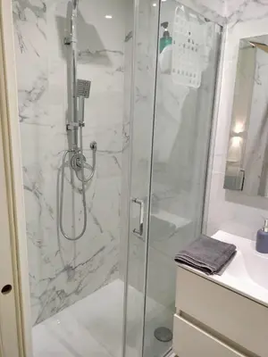 a bathroom with a shower with a glass door at Vatican room - all you need to sleep 1 in Rome