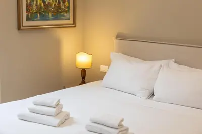 a bedroom with a white bed with towels on it at Amazing 3 Bedrooms Prati Vatican in Rome