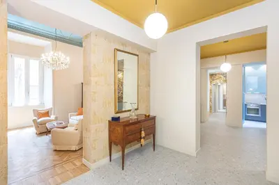 a living room with a table and a mirror at Amazing 3 Bedrooms Prati Vatican in Rome