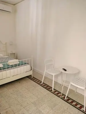 a bedroom with a bed and a table and chairs at Vatican Room -all you need to sleep 2 in Rome