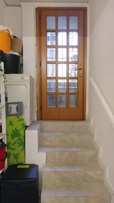 a stairway with a wooden door and a window at Vatican Room -all you need to sleep 2 in Rome