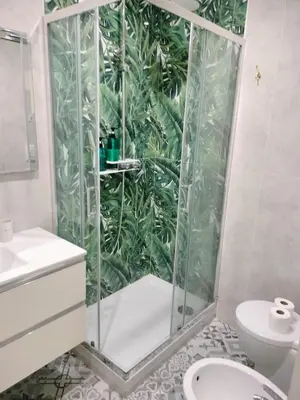 a bathroom with a shower with a plant wall at Vatican Room -all you need to sleep 2 in Rome