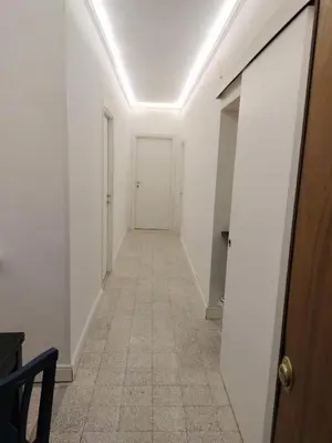 a hallway with white walls and a white door at Vatican Room -all you need to sleep 2 in Rome