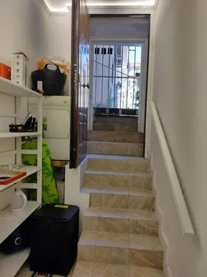 a stairway leading up to a door in a room at Vatican Room -all you need to sleep 2 in Rome