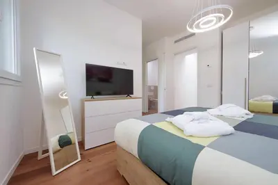 a bedroom with a bed with a tv and a mirror at Sabelli 2 Villa Indipendente nel Cuore di Roma in Rome