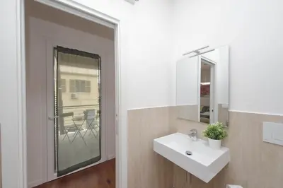 a bathroom with a sink and a mirror at Sabelli 2 Villa Indipendente nel Cuore di Roma in Rome