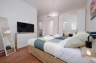 a bedroom with a large bed and a flat screen tv at Sabelli 2 Villa Indipendente nel Cuore di Roma in Rome