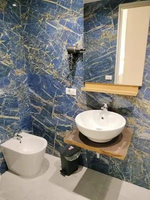 a bathroom with a toilet and a blue marble wall at Vatican Room- all you need to sleep 3 in Rome