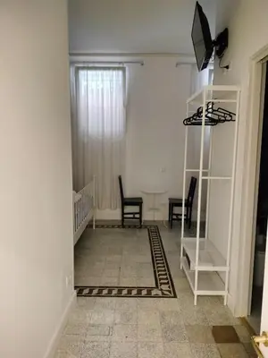 a shower in a bathroom with blue tiles at Vatican Room- all you need to sleep 3 in Rome