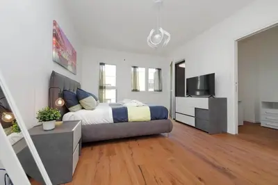 a bedroom with a bed and a flat screen tv at Sabelli 3 Villa Indipendente con Studio Privato in Rome