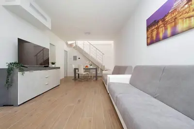 a living room with a couch and a large tv at Sabelli 3 Villa Indipendente con Studio Privato in Rome