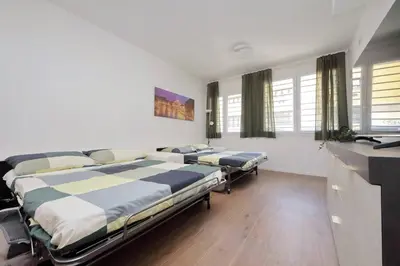 two beds in a room with windows at Sabelli 3 Villa Indipendente con Studio Privato in Rome