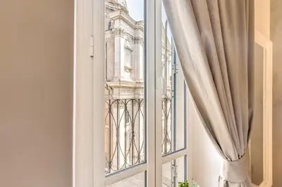 a window with a view of a building at The Spanish Suite Campo de' Fiori in Rome