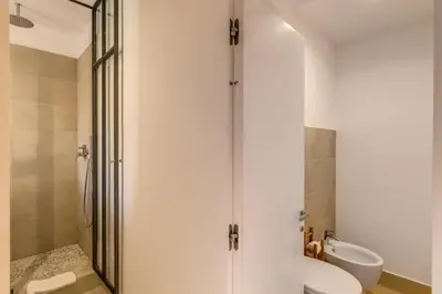 a bathroom with a shower and a toilet and a sink at The Spanish Suite Campo de' Fiori in Rome