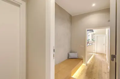 a hallway of a home with white walls and wooden floors at The Spanish Suite Campo de' Fiori in Rome