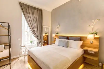 a bedroom with a large bed and a window at The Spanish Suite Campo de' Fiori in Rome