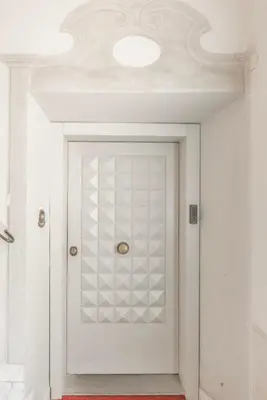 a white door in a room with a ceiling at La Dolce Vita - Elegant retreat in the heart of Rome in Rome